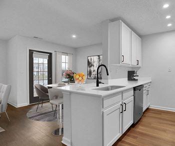 a kitchen with white cabinets and a large island
